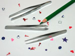 Craft tweezers and tiny eyelets, brads, and pieces of paper